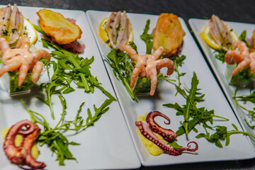 Cold seafood appetizer served in a seaside restaurant. A dish of fresh shellfish and seafood served in a coastal setting with ocean views and ambiance.