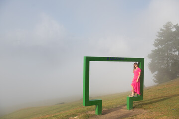 Girl in a pink dress in the mountains of Georgia