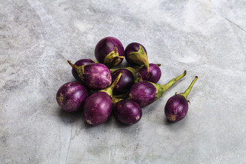 Small organic young purple round eggplant