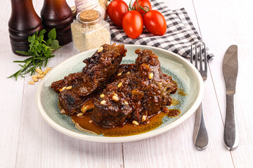 Prepared tasty beef ribs with sauce