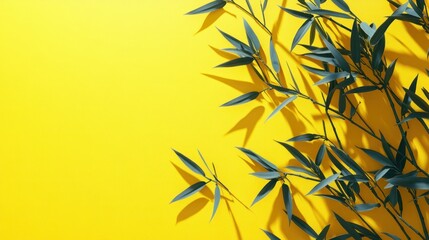 Green leaves cast shadows on a bright yellow background.