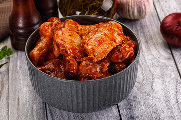 Raw marinated buffalo chicken wings