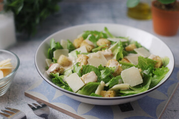 A bowl with classic Caesar salad	