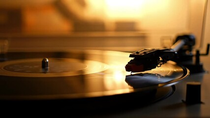 Spinning vinyl record on turntable in warm retro setting   - Powered by Adobe