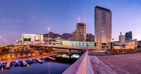 Panorama: Cape Town city lights reflecting on canal at CTICC after sunset, South Africa