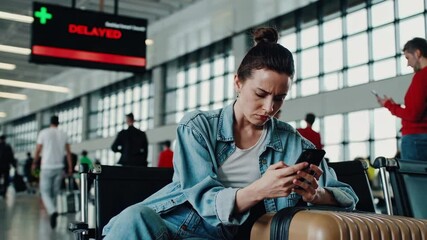 Young tired woman waiting at airport - Powered by Adobe