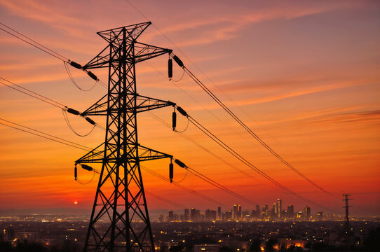 Electric tower providing energy to a big city in the evening.