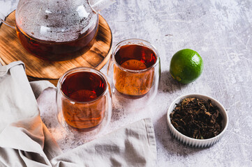 Home brewed earl grey tea in cups and teapot on table