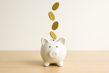 Coins falling to white piggy saving , Financial and money deposit concept