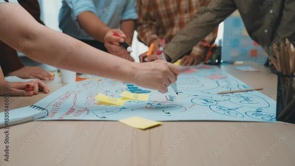 Poster a diverse team engaged in a lively brainstorming session, using sticky notes and visual aids to gene