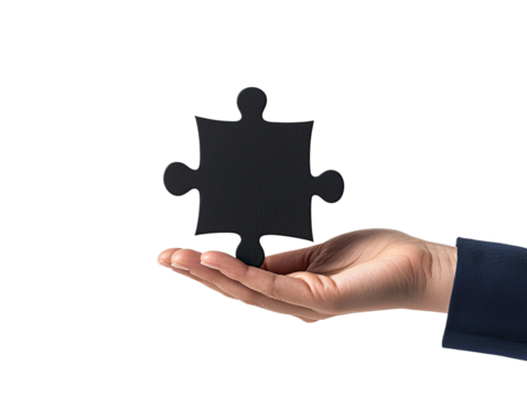 A hand holds a single black puzzle piece, symbolizing problem-solving and the search for missing connections.
