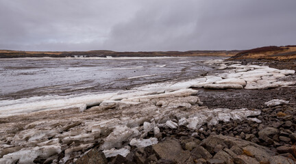 Icelandic frozen lake with ice cubes, Iceland, early in springtime. Icelandic Arctic landscape