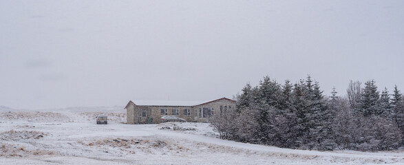 Snow falling on remote house in iceland during winter storm