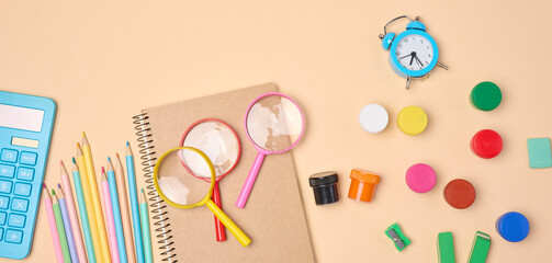 Stationery and school supplies such as pencils, magnifying glass, calculator and notepad are...