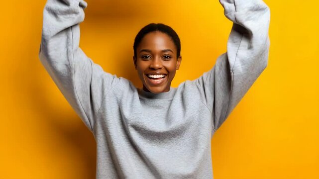 Joyful Woman Smiling and Holding a Cardboard Package on Yellow Background for Happiness Lifestyle and Energy Concepts

