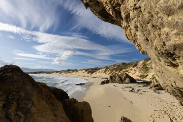 Empty Sandy Ocean Beach with Rocks in the Foreground