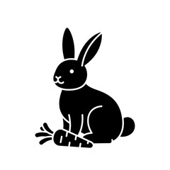 Obraz premium Black silhouette of a rabbit sitting next to a carrot 