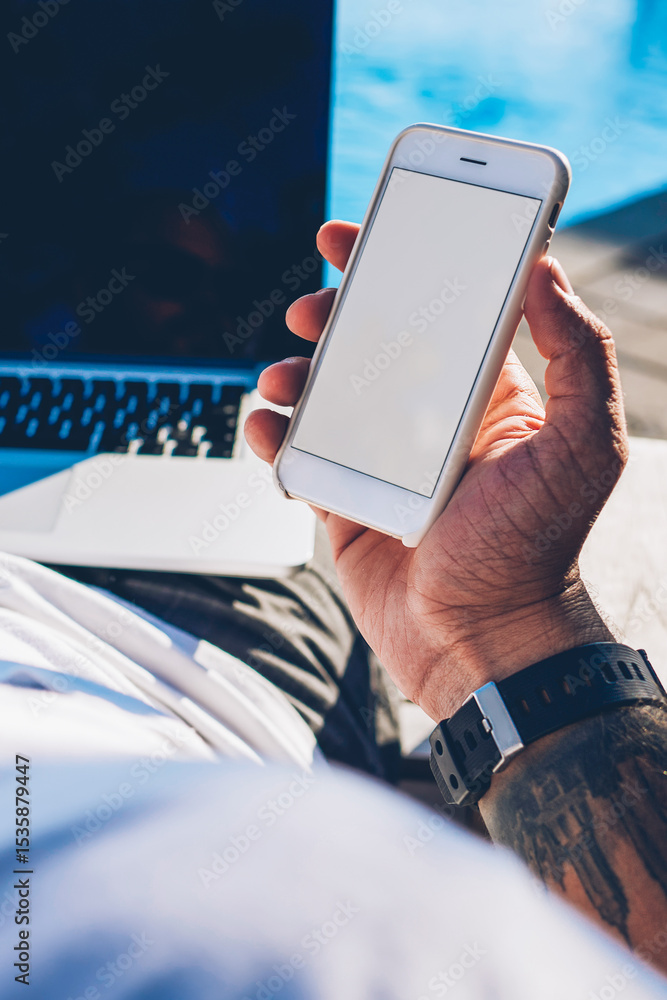 Poster croped image of man tourist holding modern smartphone with blank copy space screen for your advertis