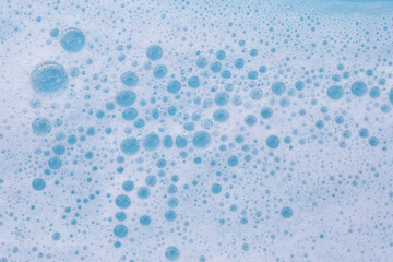 Blue water with white foam bubbles