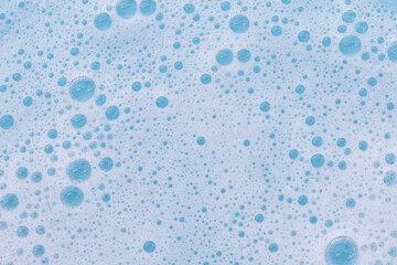 Blue water with white foam bubbles
