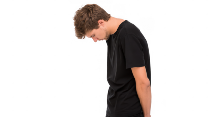 Young man slouching with head down in a black t shirt, reflecting sadness and discomfort against a transparent background