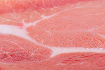 Thinly sliced ham meat as a background macro photo.