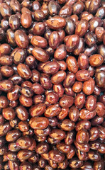 Brown olives with rich texture ready for culinary delights in a vibrant market setting
