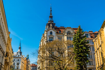 A view of ornate buildings with spires around the old town square in central Prague in springtime