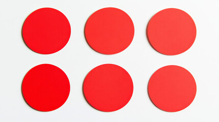 Collection of blank red circular adhesive labels on a white background, perfect for marking or categorization