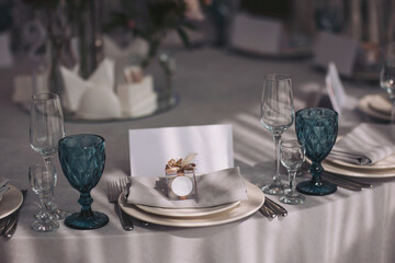 Elegant table setting for a celebration in an upscale venue during the evening, adorned with decorative elements and soft lighting for a warm ambiance