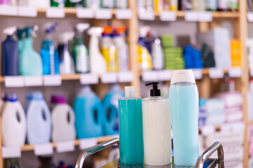 Shampoo and shower gel on shelf in household chemicals store
