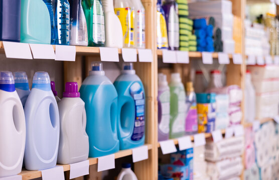 Assorted bottles of detergents and cleaning supplies neatly displayed for customers on shelves of home care products store