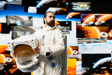Modern man astronaut drifting in zero gravity during a space journey, reflecting interstellar...