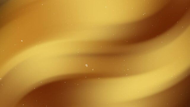 Gold gradient swirling abstract waves with speckles create a luxurious design suitable for branding, packaging, backgrounds, and decorative prints.