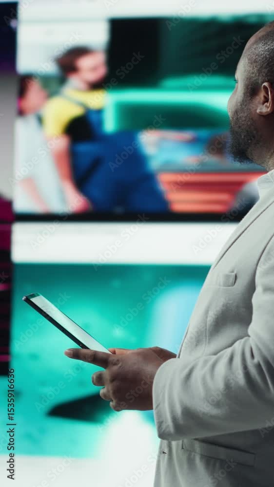 Poster vertical video smiling person using tablet, enjoying leisure time with online video content. joyful 