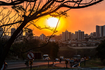 Afternoon with orange sky, the result of the massive presence of soot and pollutants in the atmosphere, low air humidity, high temperatures, smoke and fire