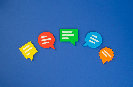 Multicolored conversation bubbles. Replicas and suggestions. Comments, ideas and opinions. Group therapy. Collaborative teamwork. Dialogue