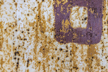 Aged painted metal surface with scattered rust and peeling texture in purple and brown hues