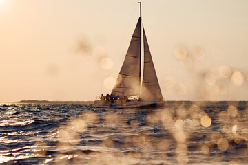 Sailing regatta in the Gulf of Finland at sunset, sailing yacht competing in a race, splashing...