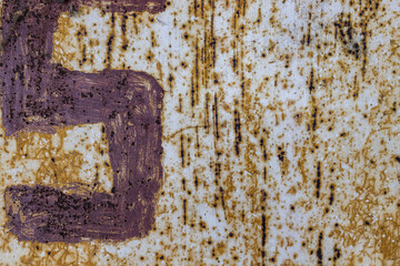 Weathered metal surface with peeling paint and scattered rust spots in close-up detail