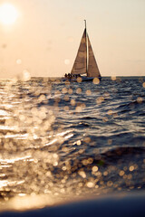Sailing regatta in the Gulf of Finland at sunset, sailing yacht competing in a race, splashing...
