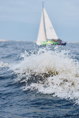 Sailing regatta in the Gulf of Finland at sunset, sailing yacht competing in a race, splashing...