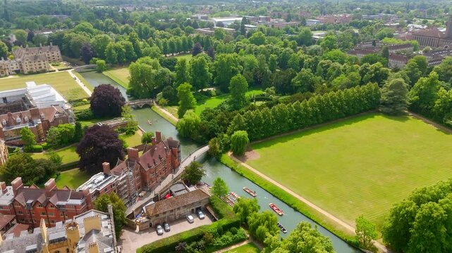 Aerial view of punting on the River Cam and the green meadows of Cambridge University on a summer day, UK
