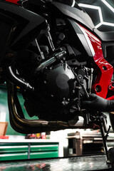 Motorcycle crankcase inspection with ratchet wrench ensures performance efficiency. Mechanic working on motorcycle crankcase during full maintenance inspection.