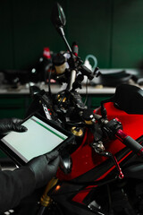 Mechanic performing system diagnostics via tablet. Motorcycle system diagnostic, scanning for...