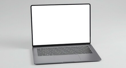 Fototapeta premium A silver laptop is open, displaying a blank white screen, against a plain light background.