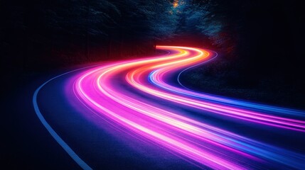 Winding road at night, vibrant light trails