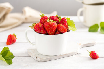 Fresh strawberries in a bowl, summer fruits. Bright background. 