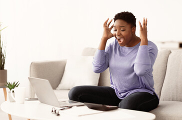 Celebrating Victory. Overjoyed african american curvy woman happy with money win, satisfied about...