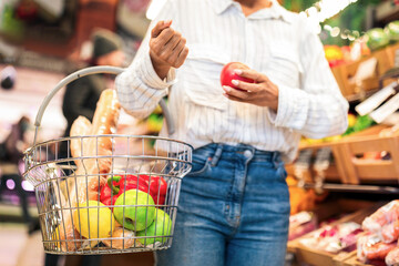 Black Lady Choosing Fresh Organic Fruits And Vegetables During Grocery Shopping In Modern...